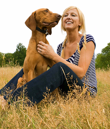 Happy woman with her beautiful brown dog